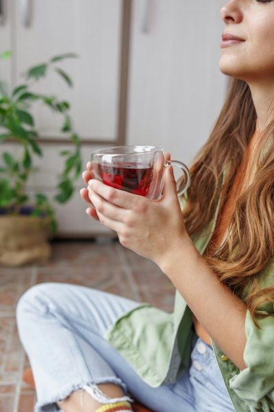 Woman drinking tea relaxing at home